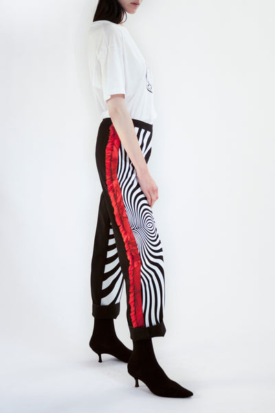 tapered pants with psychedelic front print and fringed side seam